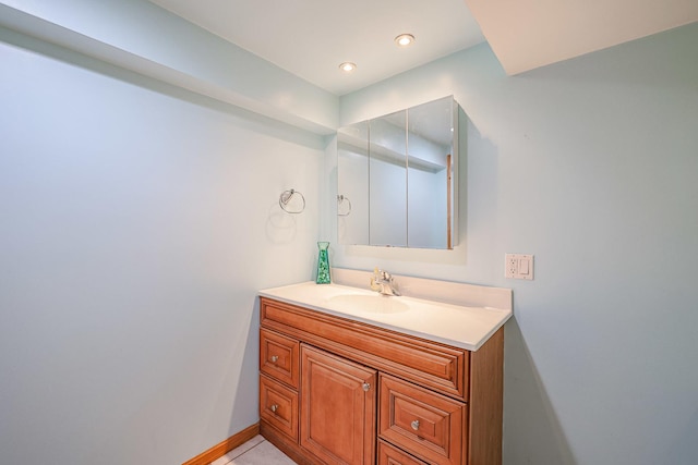 bathroom featuring recessed lighting, baseboards, and vanity