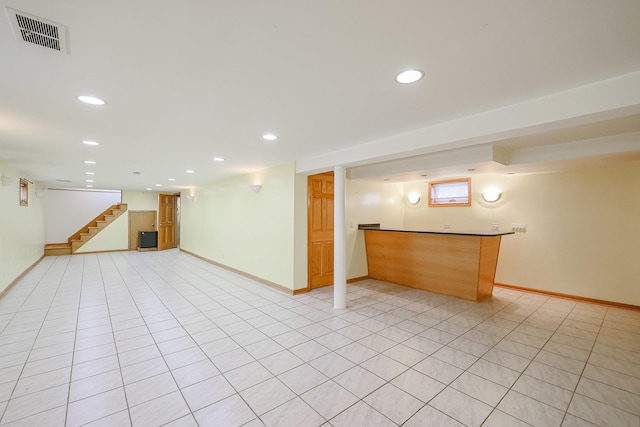 below grade area featuring visible vents, recessed lighting, stairway, and baseboards