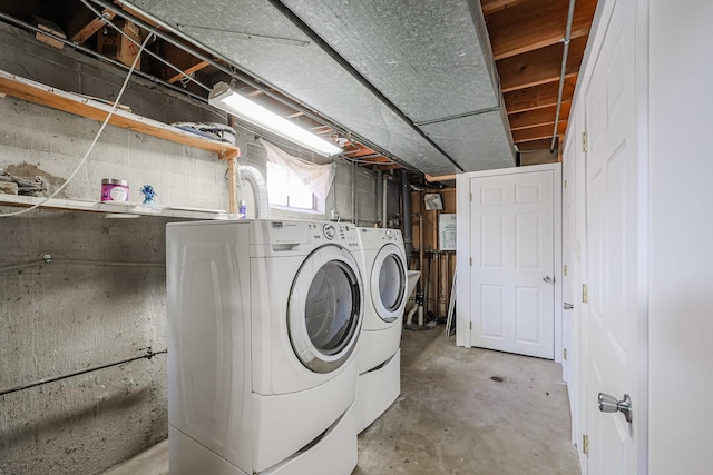 clothes washing area with washer and clothes dryer and laundry area