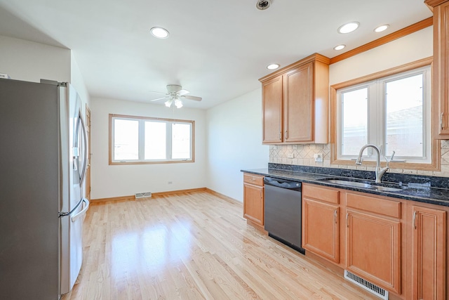 kitchen with visible vents, ceiling fan, a sink, dishwasher, and stainless steel fridge