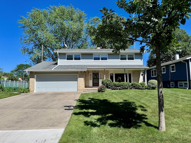 view of front of home with a front lawn, driveway, fence, covered porch, and brick siding