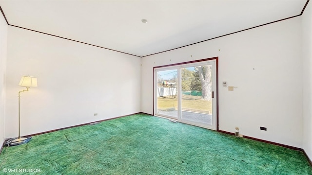 empty room featuring carpet flooring and baseboards