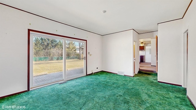 unfurnished room with carpet, visible vents, and baseboards