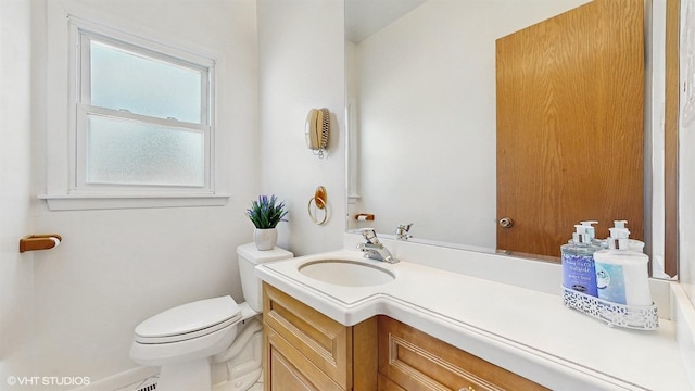 bathroom with toilet and vanity