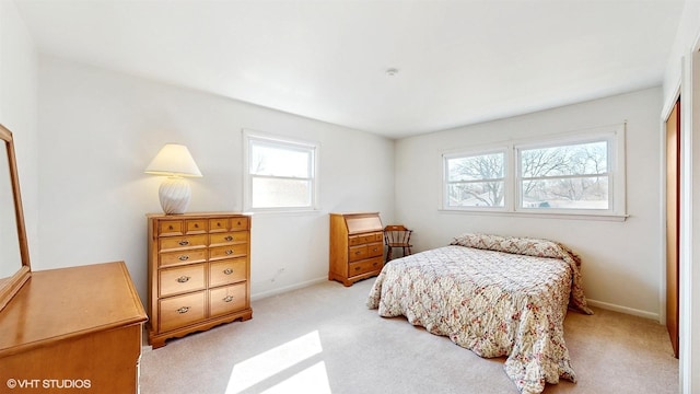 bedroom featuring baseboards and light carpet