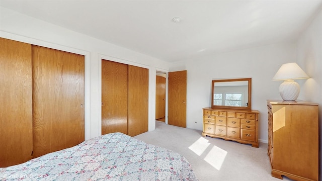 carpeted bedroom featuring two closets