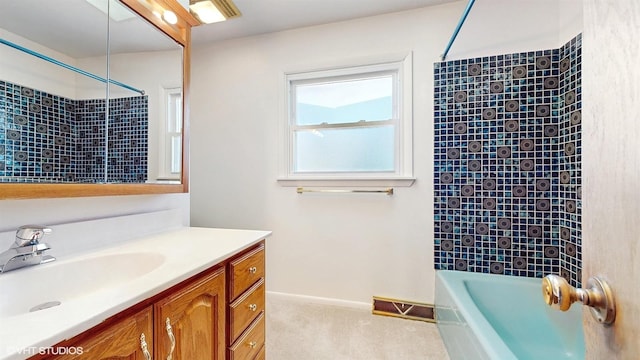 bathroom with visible vents, baseboards, vanity, and shower / bathtub combination