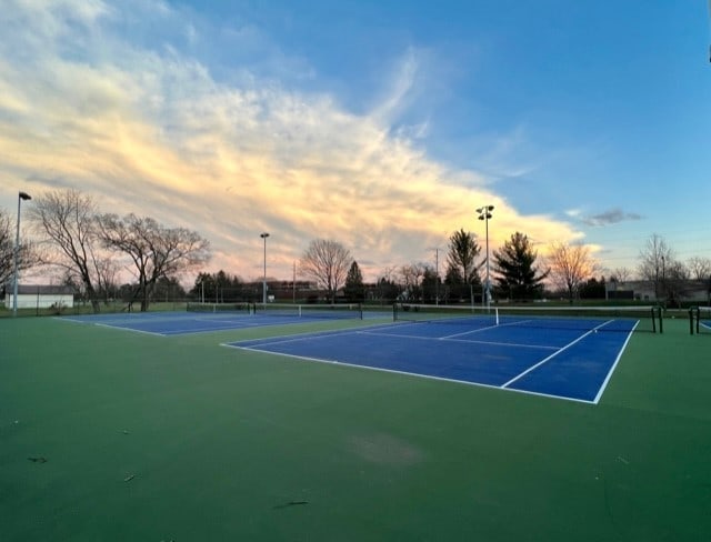 view of sport court featuring fence