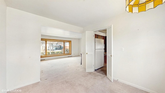 interior space featuring baseboards and carpet floors