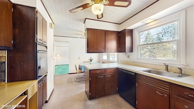 kitchen with a ceiling fan, a sink, wall oven, light countertops, and dishwasher