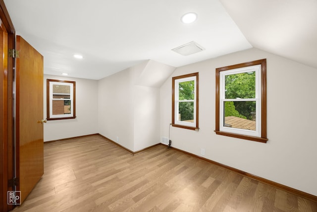 bonus room with recessed lighting, light wood-style flooring, baseboards, and lofted ceiling