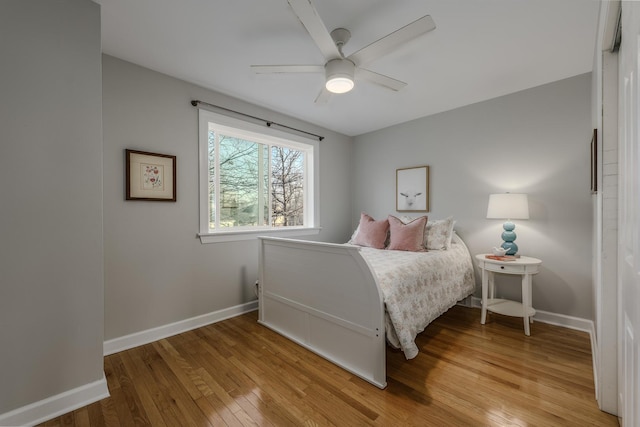 bedroom featuring ceiling fan, baseboards, and hardwood / wood-style floors