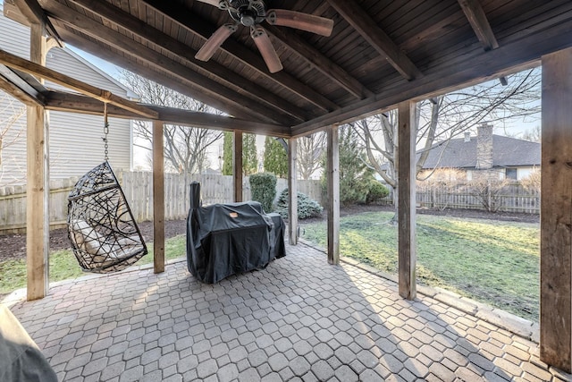 view of patio / terrace featuring area for grilling, a fenced backyard, and a ceiling fan