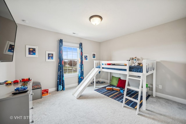 bedroom featuring visible vents, baseboards, and carpet