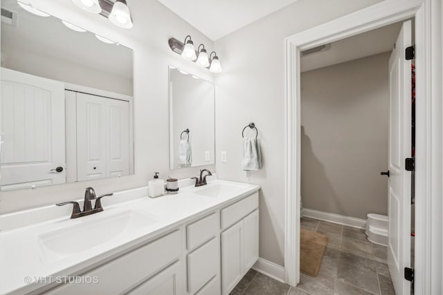 full bath with double vanity, visible vents, baseboards, and a sink