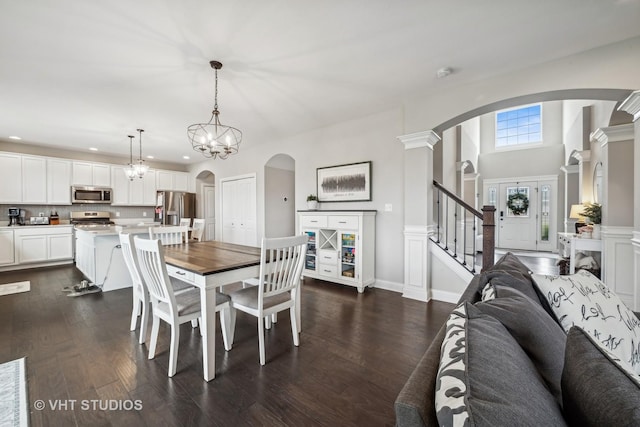 dining room featuring dark wood-type flooring, recessed lighting, stairway, arched walkways, and baseboards