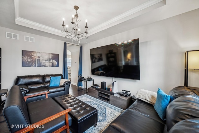 living room featuring visible vents, crown molding, and a tray ceiling