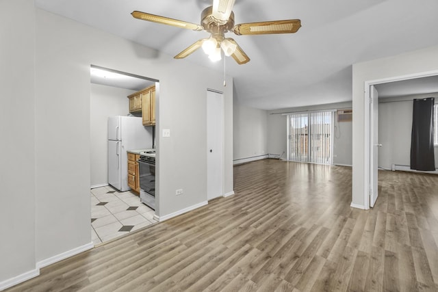 unfurnished living room with baseboard heating, light wood-style flooring, baseboards, and ceiling fan