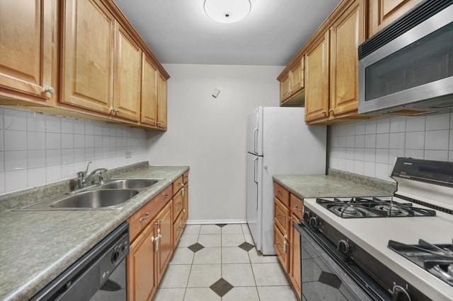 kitchen with light tile patterned flooring, a sink, black dishwasher, range with gas cooktop, and stainless steel microwave