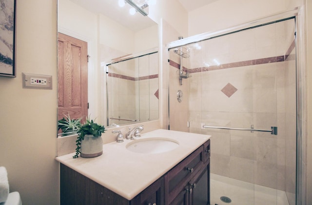 full bathroom with vanity and a shower stall