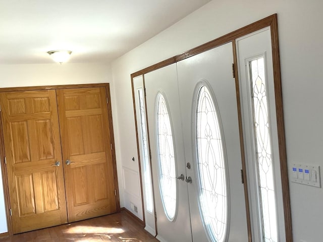 foyer with french doors and wood finished floors