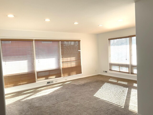 empty room featuring recessed lighting, carpet, visible vents, and baseboards