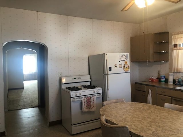 kitchen with wallpapered walls, ceiling fan, arched walkways, white appliances, and open shelves