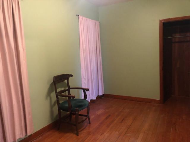 sitting room with wood finished floors and baseboards