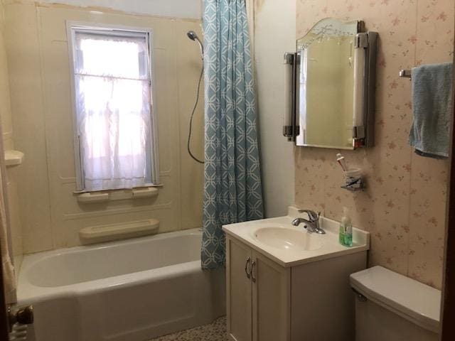 full bathroom with toilet, vanity, wallpapered walls, and shower / tub combo