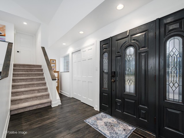 foyer featuring dark wood finished floors, stairs, recessed lighting, and baseboards