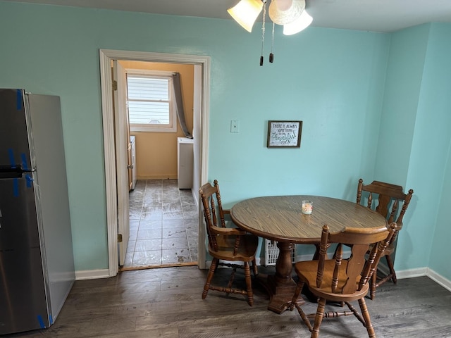 dining space with washer / clothes dryer, wood finished floors, baseboards, and ceiling fan