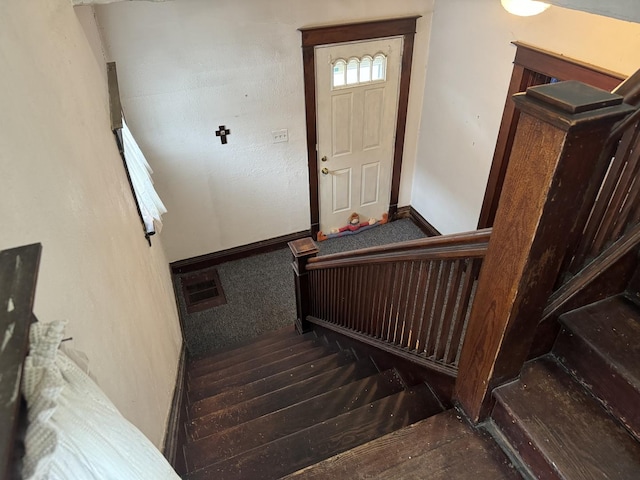 stairs featuring visible vents and baseboards