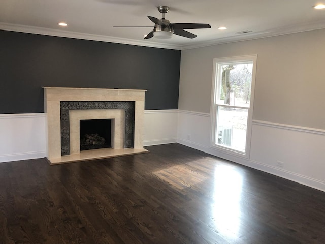 unfurnished living room with dark wood-style floors, a fireplace, crown molding, and ceiling fan