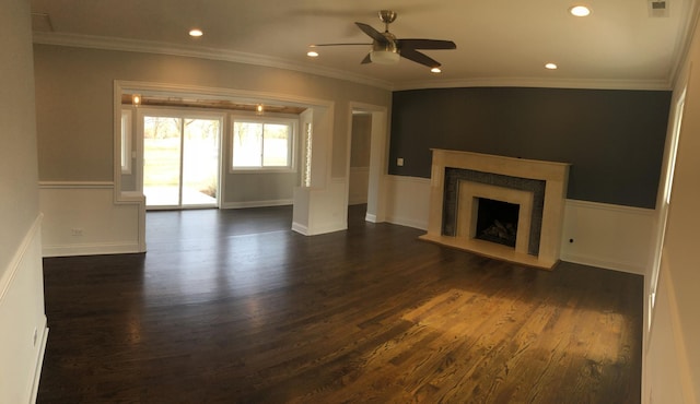 unfurnished living room featuring a fireplace with raised hearth, crown molding, ceiling fan, and dark wood-style flooring