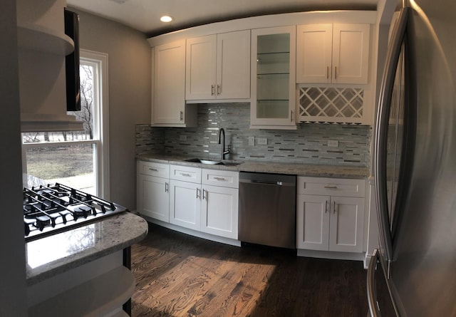 kitchen featuring a sink, dark wood-style floors, white cabinetry, appliances with stainless steel finishes, and glass insert cabinets