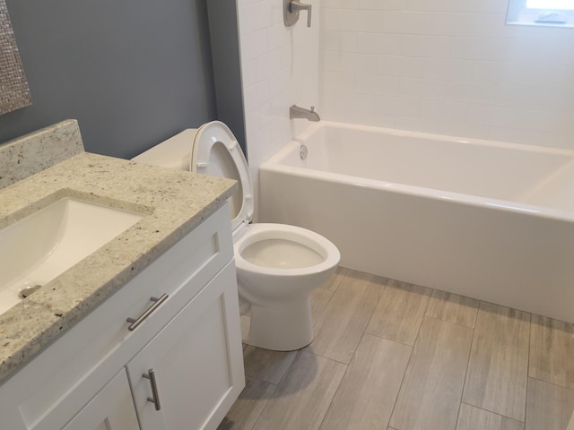 full bathroom with shower / washtub combination, toilet, vanity, and wood tiled floor