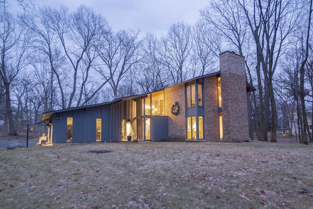 exterior space with brick siding and a chimney