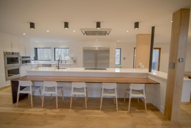 kitchen with white cabinets, appliances with stainless steel finishes, modern cabinets, and a sink