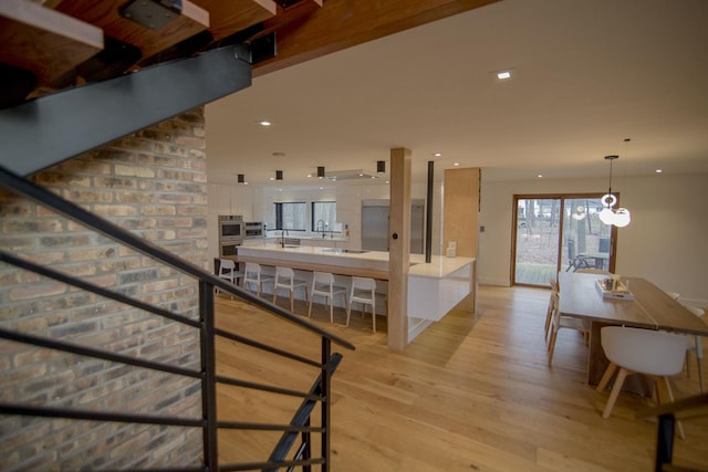 staircase with recessed lighting and wood finished floors