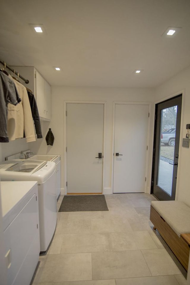 clothes washing area featuring recessed lighting and cabinet space