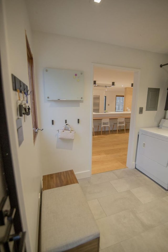 bathroom with electric panel, baseboards, and washer / clothes dryer