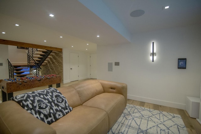 living room featuring stairway, recessed lighting, baseboards, and light wood-style floors