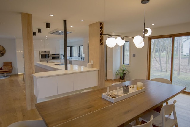 dining area featuring recessed lighting and light wood finished floors