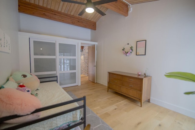 bedroom with light wood-type flooring, a ceiling fan, lofted ceiling with beams, wooden ceiling, and baseboards