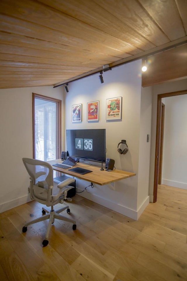 office area with light wood-type flooring, baseboards, and wood ceiling