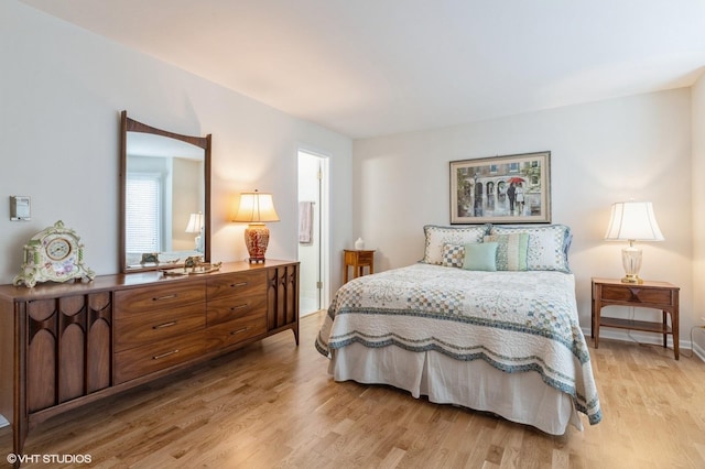 bedroom featuring light wood-type flooring and baseboards