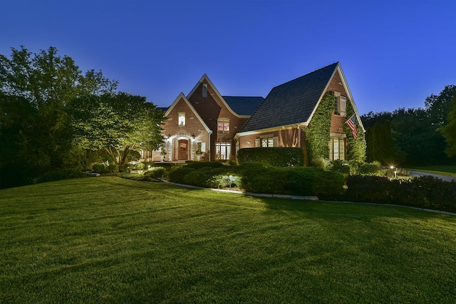 view of front of house with brick siding and a front yard