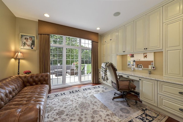 office area featuring recessed lighting, built in study area, and wood finished floors