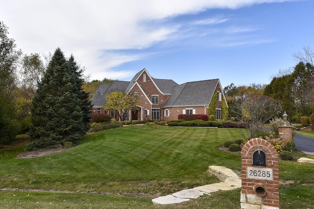 view of front of property with a front yard and brick siding