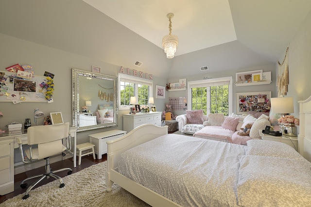 bedroom featuring visible vents, lofted ceiling, and wood finished floors